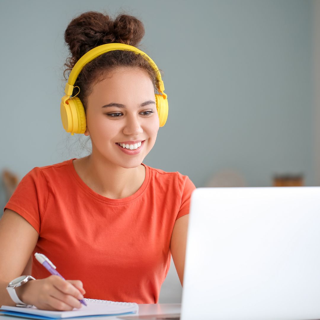 a woman smiling while on the computer